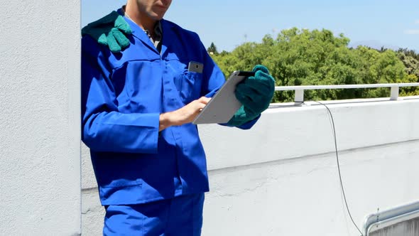 Male worker using digital tablet at solar station 4k