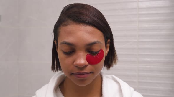 Woman Uses Red Eye Patches Antiwrinkle