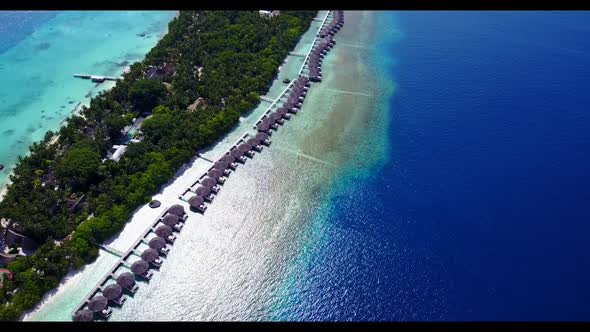 Aerial above nature of perfect coastline beach vacation by transparent sea with white sandy backgrou