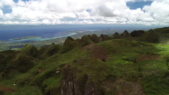 Aerial view of peak Chocolate hills and cloudy sky in Badian, Philippines.