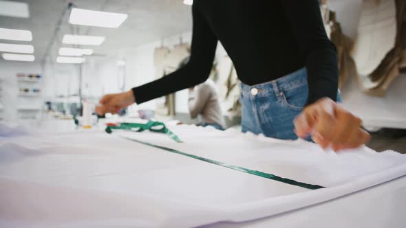 Sewing Workshop Unknown Woman Taking Measurements of Fabric By Tape Measure Colleague Clarifying