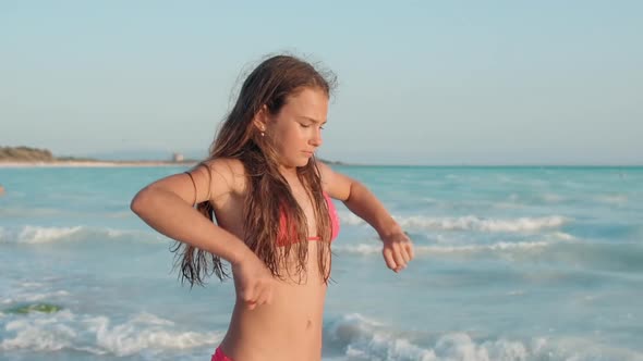 Focused Woman Doing Exercises at Seashore