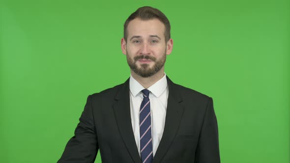 Ambitious Businessman Showing OK Sign Against Chroma Key