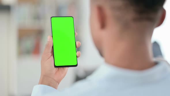 African Man Using Smartphone with Green Chroma Key Screen