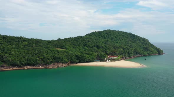 Aerial: island of pigs ubatuba brazil with view of the jungle and beach from the air and view of the