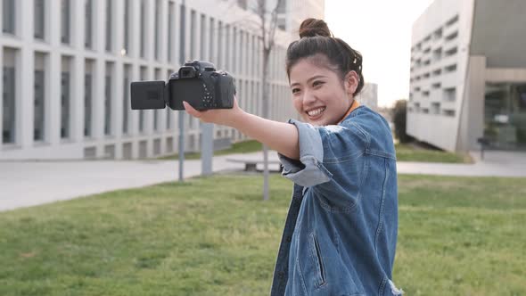 Asian woman vlogging and using camera, social media influencer content creator lifestyle