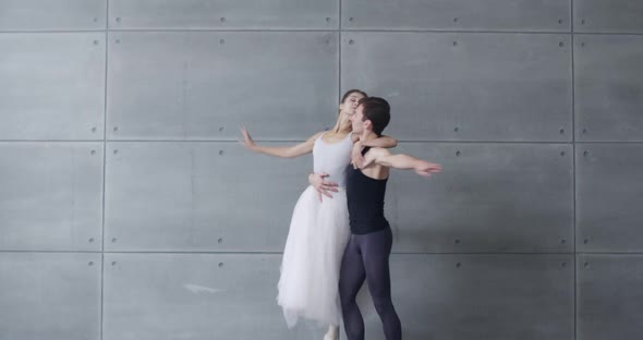 Elegant Couple of Classical Ballet Dancers Rehearsing a Dance on a Gray Background Romantic Dance of