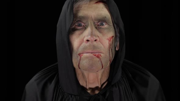 Old Executioner Halloween Makeup and Costume. Elderly Man with Blood on His Face