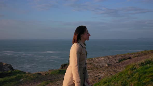 A Brooding Girl Walks Along the Ocean