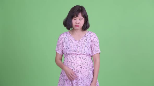 Stressed Asian Pregnant Woman Looking Bored and Tired
