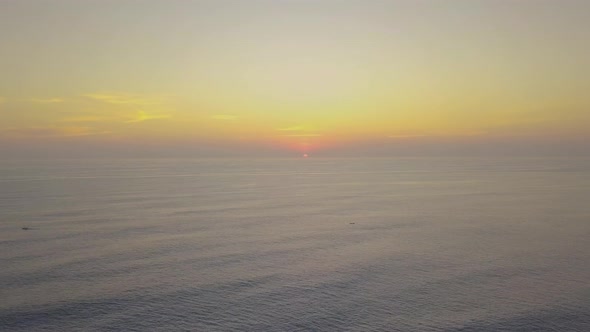 Timelapse Soothing View of Smooth Ocean Waves and Orange Sunset Sky Horizon.