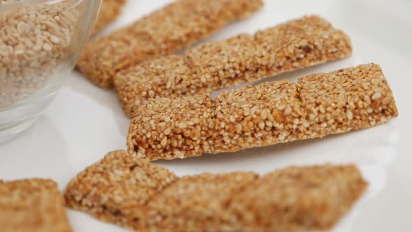 Rotating view of sticks made of sesame seeds isolated on plate