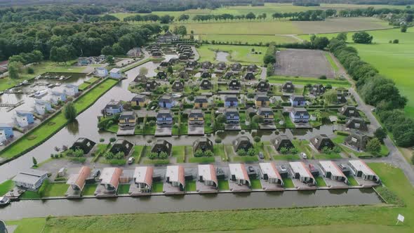 Aerial Flyover a Small Dutch Holiday Park during Summer with Different Houses surrounded by Water