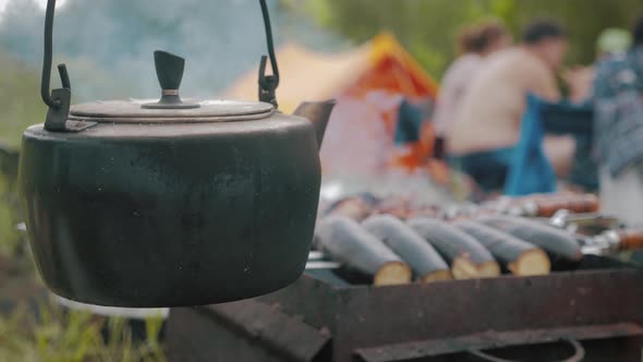 Old Teapot Boils on Campfires. Fire, Kettle, Camping. Set Fire To Boil Hot Water in the Kettle.