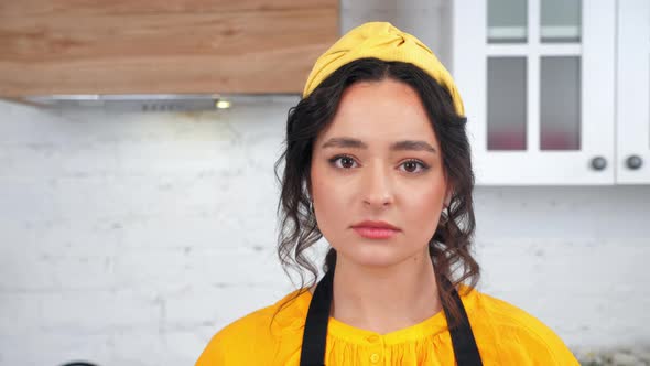 Close Up Sad Beautiful Housewife Turns Head Looking Camera in Home Kitchen
