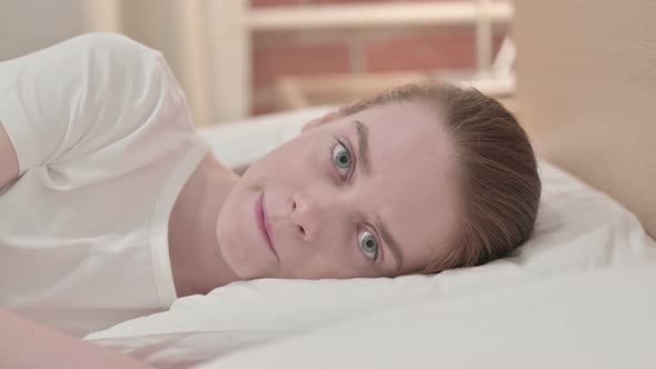 Worried Redhead Young Woman Feeling Sad in Bed