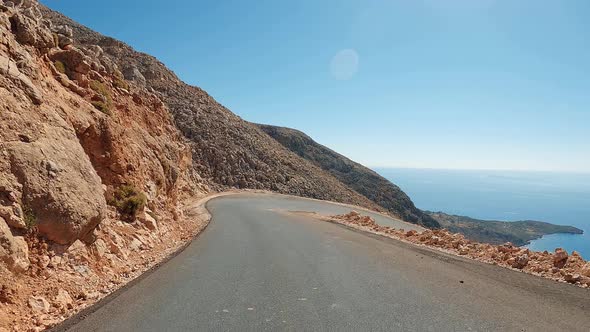 Zig-zag curve road and U-turns in a desert canyon. Coast POV driving in the mountains