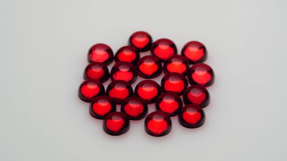 Natural Red Garnet Gemstone on the White Background on the Turning Table