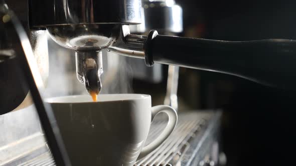Slow Motion Video. Coffee Machine Making Espresso in Cafe. Barista Making Coffee in Bar. Espresso