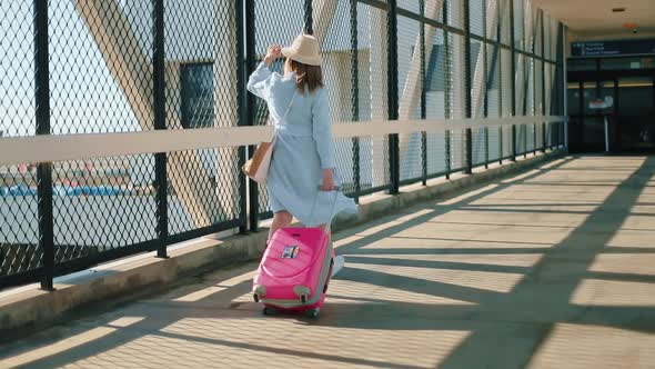 Slow Motion of Woman in Face Mask. Woman Walking Between Airport Terminals 