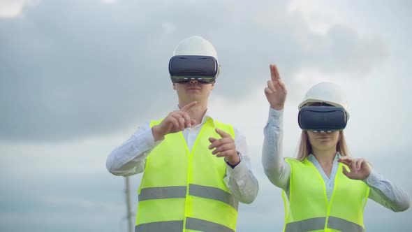 A Man and a Woman Engineer in VR Glasses Control the Power Distribution of Electric Networks and the
