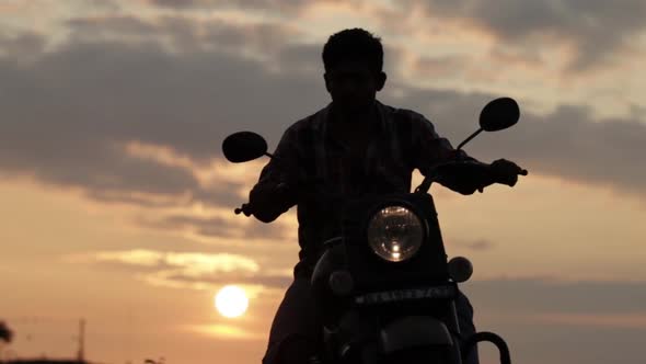 Guying two wheeler in sue bg. This was shot in Valacchil view point, Mangalore. KA India at Sunrise.