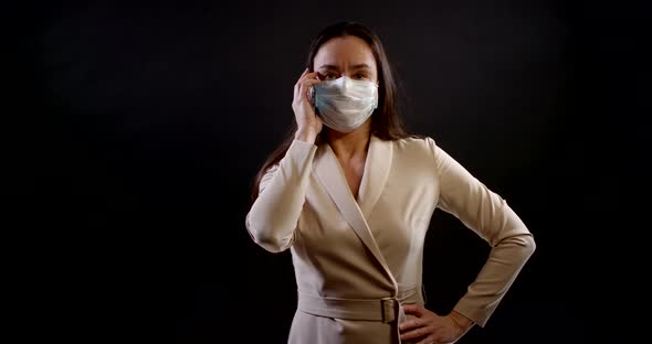 Adult Woman with Face Mask for Protection From Virus, Calling By Mobile Phone