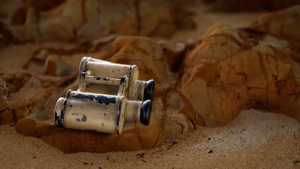 Old German Military Binoculars on the Sand Beach