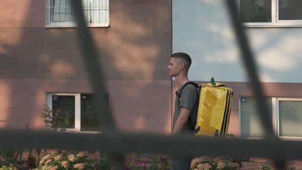 Food delivery during quarantine in a yellow thermal bag.