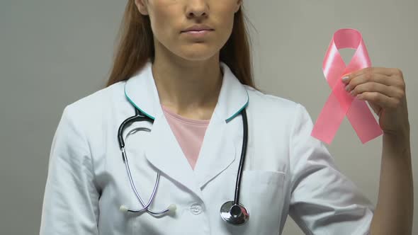 Doctor Holding Pink Ribbon