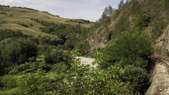 Mountain Pass And Rugged Terrain With Lush Green Forest In Maramures, Romania. wide shot