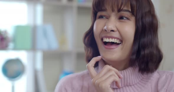 Headshot portrait of young woman laughing and smile with happy