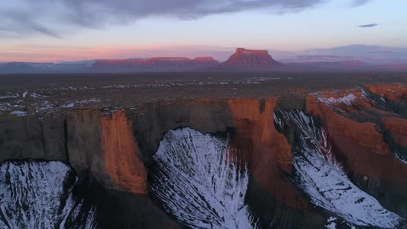 Flying over colorful desert landscape at sunrise in Utah