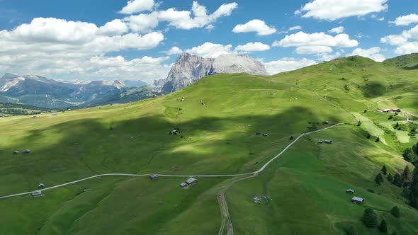 Dolomites Mountains with hiking paths and wooden cottages