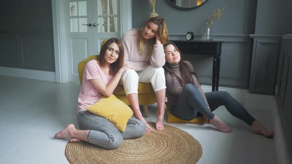 Three Friends are Sitting on the Roof of the House and Chatting