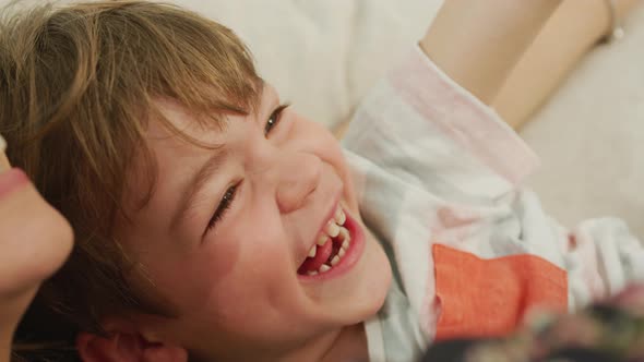 Happy child laughing in mother's arms