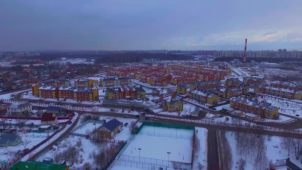 Aerial view of a Russian neighborhood during a light snowfall in winter