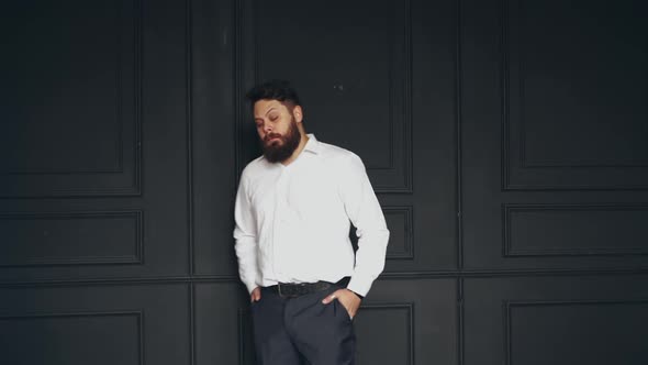 Brutal man in studio. Young casual bearded man posing in studio