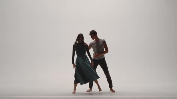 Elements of Modern Choreography Contemporary Performed By a Young Couple of Dancers on a White