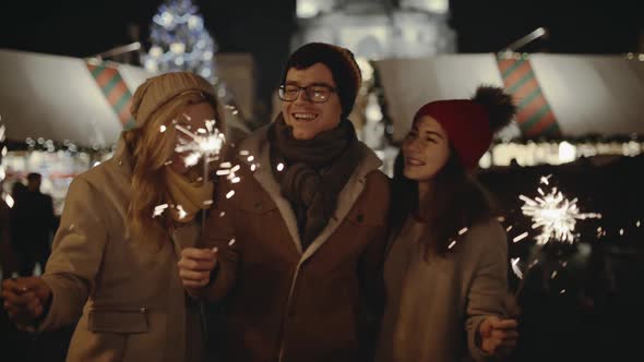 Laughing Group of Friends Having Fun at the Christmas Fair