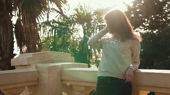 Cute Woman Standing on the Balcony.