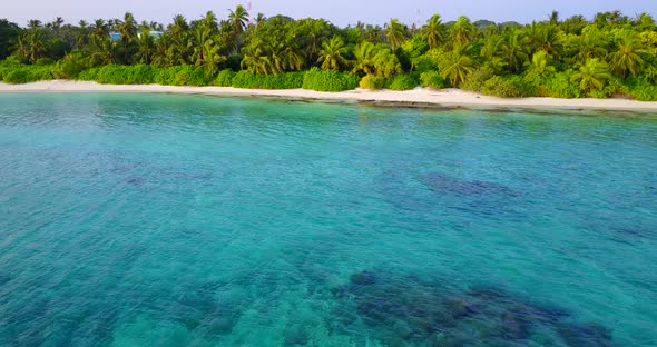 Wide angle flying island view of a white sand paradise beach and aqua turquoise water background in 