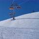 Ski lift in a ski resort in the german alps. Skiers on a ski slope on a sunny winter day. - VideoHive Item for Sale