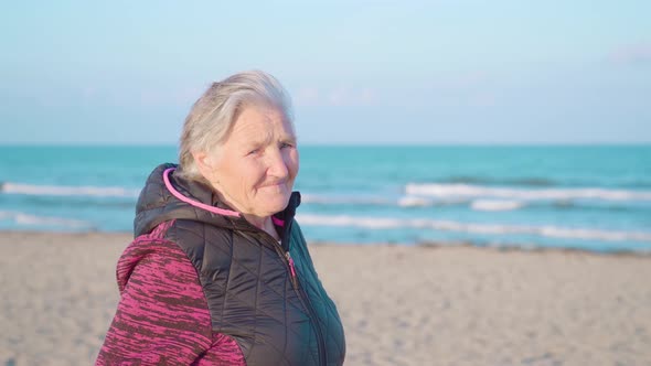 Old Woman Enjoys View of Chioggia Coast with Bright Smile