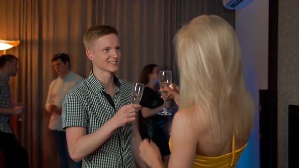 Young Guy Meet Flirting at Glamorous Party with Sexy Female Drinking Champagne.