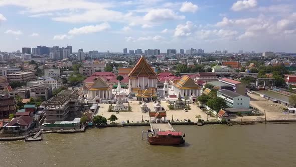 Buddhist temple on the banks of Chao Phraya river in Bangkok, aerial view