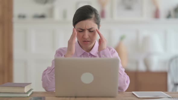 Indian Woman having Headache while Working on Laptop