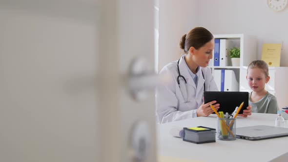 Doctor Showing Tablet Pc to Little Girl at Clinic