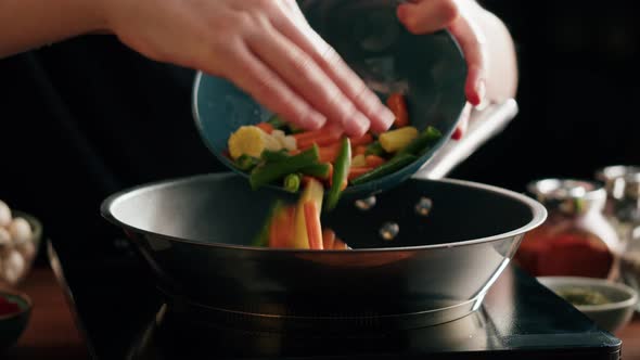 Chef Frying Vegetables in Pan Closeup