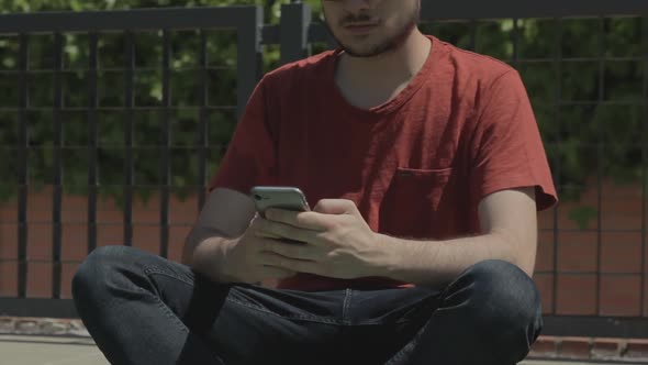 young teenager using smartphone outdoors